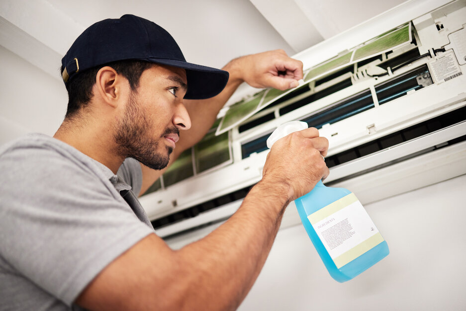 Air conditioner, cleaning and man with electrical machine check in a home with ac repair. Maintenance, spray and system wash for installation, inspection of aircon fix in a house with contractor.